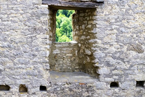 Stone window of the Reußenstein castle ruins with a view of the surrounding nature, Neidlingen