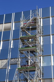 Steel scaffolding on the large glass façade of an office building