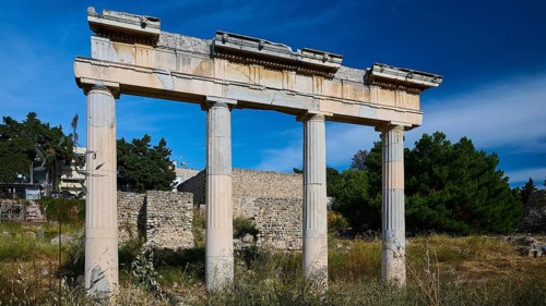 Ancient column ruins under a blue sky in a historic landscape, Archaeological site, Xysto Columned