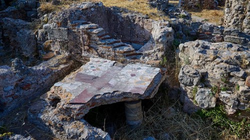 Detail of an ancient ruined site with stone structures and small staircase, Archaeological site,