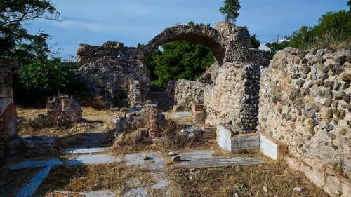 Ruins of an ancient site with stone arches and overgrown walls, Archaeological site, Western