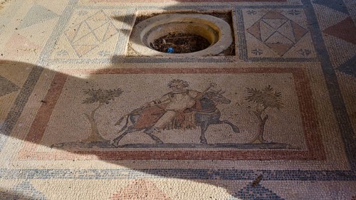 Ancient mosaic depicting a man and a horse surrounded by geometric patterns, House of Beluga