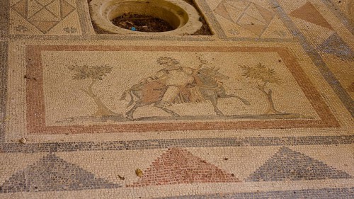 Ancient mosaic with figures and geometric patterns, showing people and a horse, Archaeological
