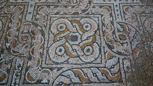 Close-up of an ancient mosaic floor with mostly round patterns, Archaeological Site, Western