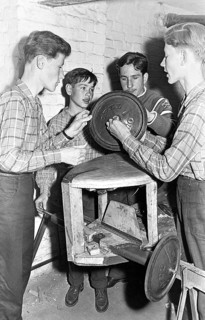 Young men craftsmen, 1950s, Group of young men working with technical equipment in a workshop,