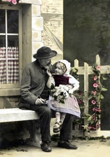 Costume, traditional dress, man and child in historical dress sitting on a bench outdoors,