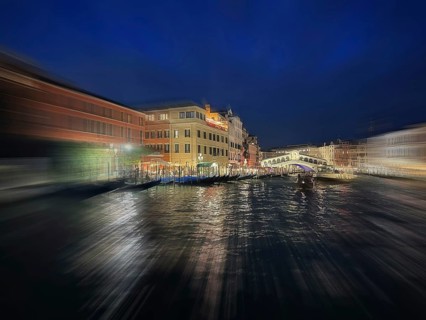 Gondolas on the Grand Canal, behind Rialto Bridge, night shot, zoom effect, lagoon city Venice,
