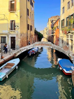 Boats and gondolas on a canal in Venice, lagoon city of Venice, Veneto, Italy