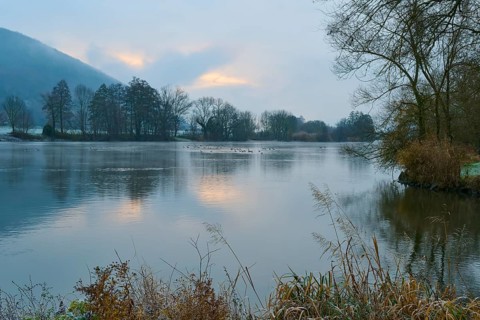 Calm river at sunrise, trees surround the lake, Laudenbach, Main, Spessart, Odenwald, Bavaria