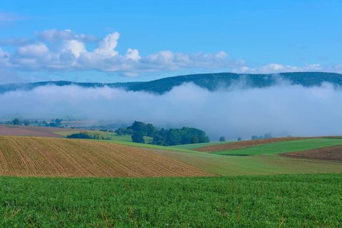 Hilly fields with fog and clear blue sky, Mönchberg, Miltenberg, Spessart, Bavaria, Germany