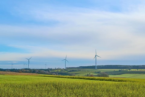 Wind turbines stand in a sunny and wide landscape, Buchen, Odenwald, Neckar-Odenwald district,