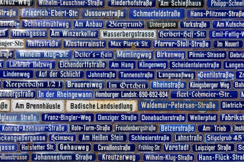 Dense collection of blue street signs with various street names, Amorbach, Odenwald, Bavaria,