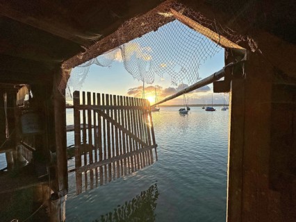 View from a boathouse onto Lake Starnberg at sunset, Bavaria, Germany