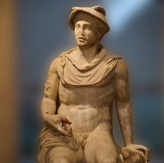 Seated marble sculpture of a man with ancient attributes such as a hat, god Hermes, classical