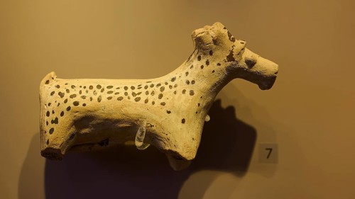 Ceramic figure of a spotted animal, exhibited in a museum-like room, Archaeological Museum, Kos