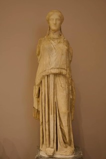 Marble sculpture of an ancient woman in elegant garb, presented in the museum, Archaeological