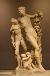 Ancient marble sculpture depicting several figures, including children and adults, satyr and Pan,