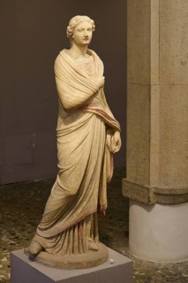 Ancient marble sculpture of a classical woman in a draped robe in the museum, Archaeological