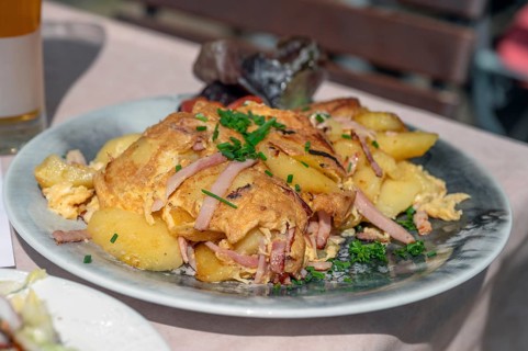Omlett with fried potatoes served in a beer garden, Bavaria, Germany