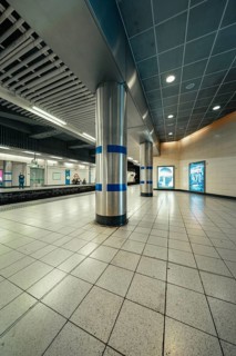 Lonely subway station with tiled floors and modern columns in a cool atmosphere, London, United