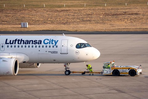 Lufthansa City Airbus A320neo is pushed from the gate onto the taxiway, ready to go, to
