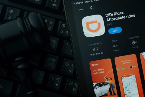 Dhaka, Bangladesh- 28 Oct 2025: An iPad displaying the DiDi Rider app against a judge's gavel and