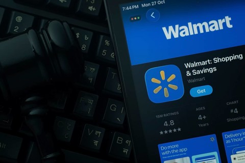 Dhaka, Bangladesh- 28 Oct 2025: An iPad displaying the Walmart app against a judge's gavel and dark