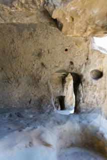 Rough stone cave walls with light and shadow effects inside, cave town Uplistsikhe, Inner Kartli