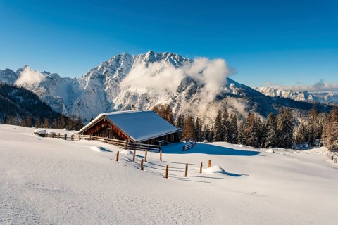 Deep snow-covered Priesbergalm, Watzmann with clouds behind, Berchtesgaden Alps, Berchtesgaden