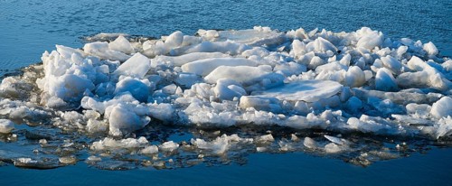 Accumulation of ice chunks on calm water surface on a cold winter day, ice floes, Elbe-Havel Canal,