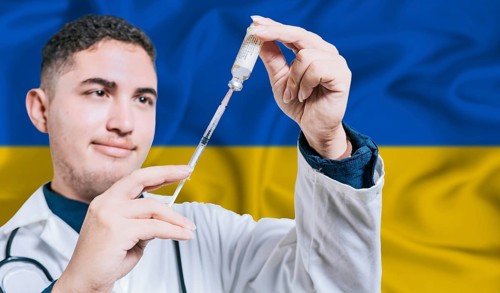 Doctor holding syringe on Ukraine flag background. Medical professional holding syringe with