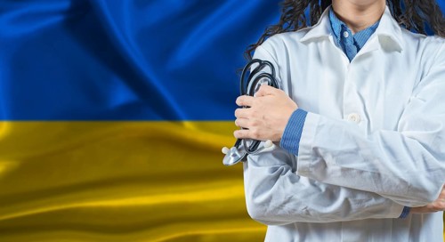 Healthcare professional with Ukraine flag background. Professional doctor holding stethoscope on