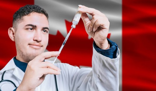 Doctor holding syringe on Canada flag background. Medical professional holding syringe with