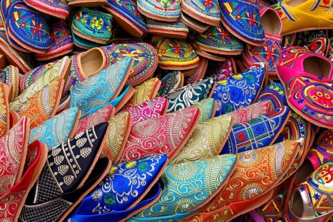 Sales stand with traditional colorful slippers at a market in Marrakech, historic old town, Medina,