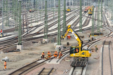 Large-scale track system with construction by several workers and a crane truck, Untertürkheim