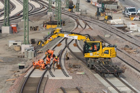 Workers and excavators renovating railroad tracks on a municipal construction site, Untertürkheim