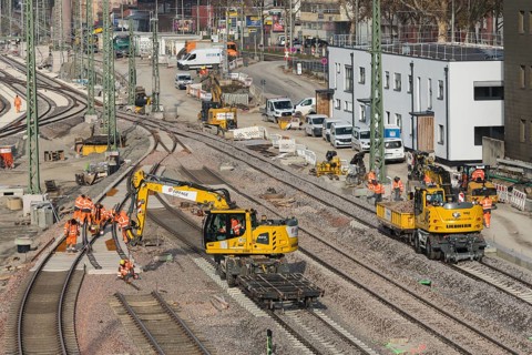 Several workers and excavators on a railway construction site in an urban area, Untertürkheim