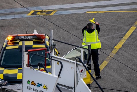 Instructor, apron supervision, an aircraft, after landing, at the parking position, at the