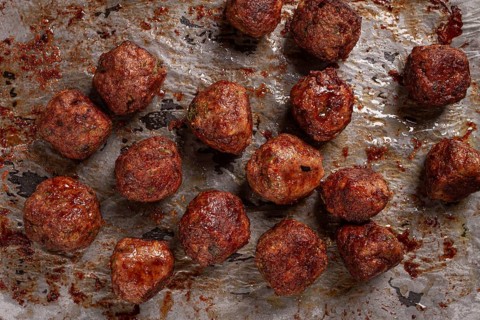 Homemade meatballs cooked to perfection on a baking tray with seasoning and herbs, Swedish