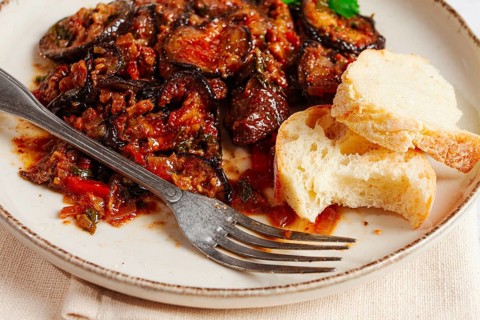 Stewed meat with eggplant is a Georgian dish, on a light background, homemade, no people