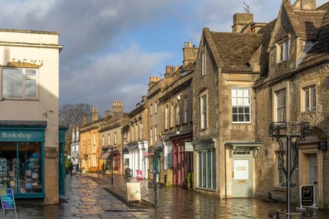 Wet pavements after rain in pedestrianised High Street are of town centre of Corsham Wiltshire,