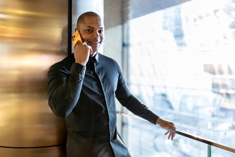 Confident businessman connecting with clients on a mobile phone, discussing future projects and