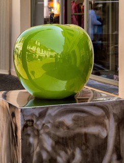 Design of a green apple in front of a shop in downtown Potsdam, Brandenburg, Germany