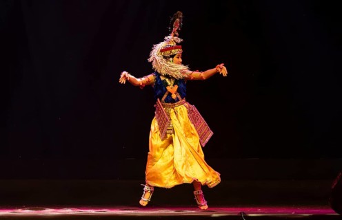 An artist perform classical Manipuri Ras Leela during a cultural evening program at Shilpgram