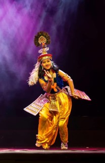 An artist perform classical Manipuri Ras Leela during a cultural evening program at Shilpgram