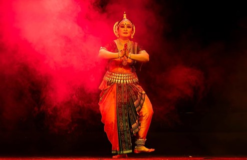 An artist perform Odissi classical dance during a cultural evening program at Shilpgram Mohotsav