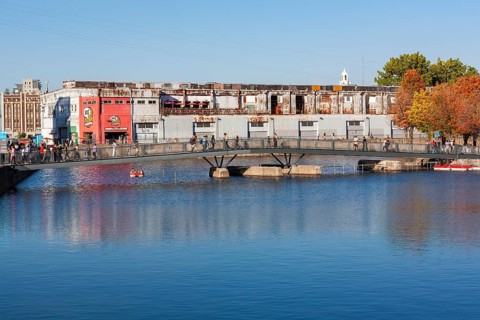 Pedestrian walkway bridge over Bonsecours basin leading to Parc du Bassin Bonsecours in autumn, Old