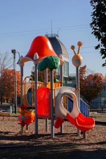 Colorful kids plastic playground equipment with slides and climbing bars in Parc du Bassin