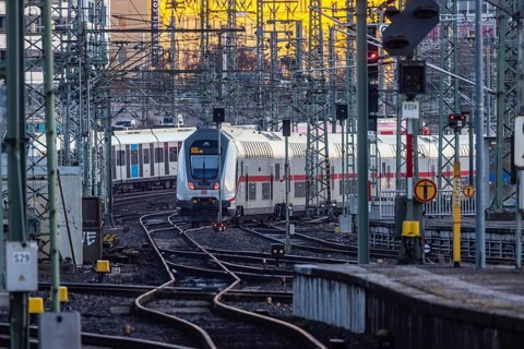 InterCity IC to Zurich leaving Stuttgart Central Station in the morning. Rail signals and overhead