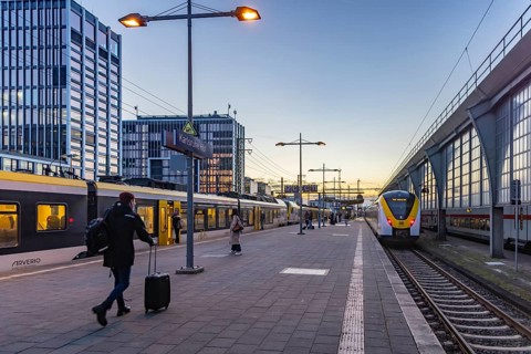 Regional train from Arverio at Karlsruhe main station in the evening. Platform with passengers.